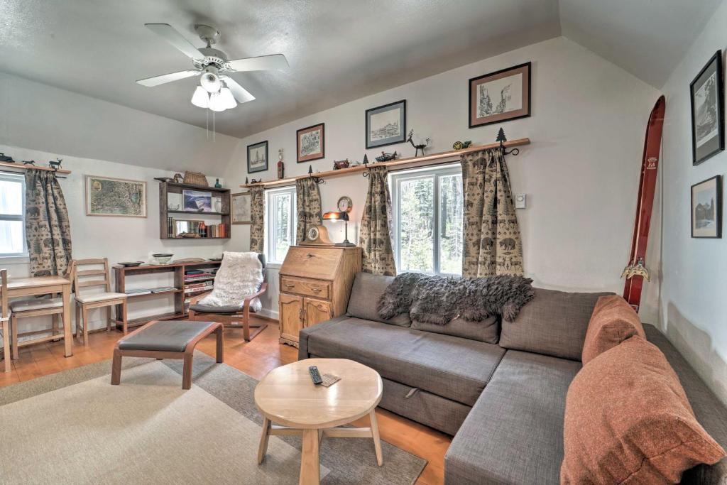 a living room with a couch and a table at Rustic Soda Springs Cabin Less Than Half-Mi to Ski Resort in Soda Springs