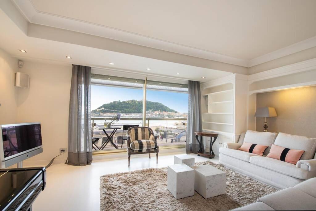 a living room with a couch and a view of the ocean at BELLA VISTA LUXURY APARTMENT. BAY VIEWS. PARKING in San Sebastián