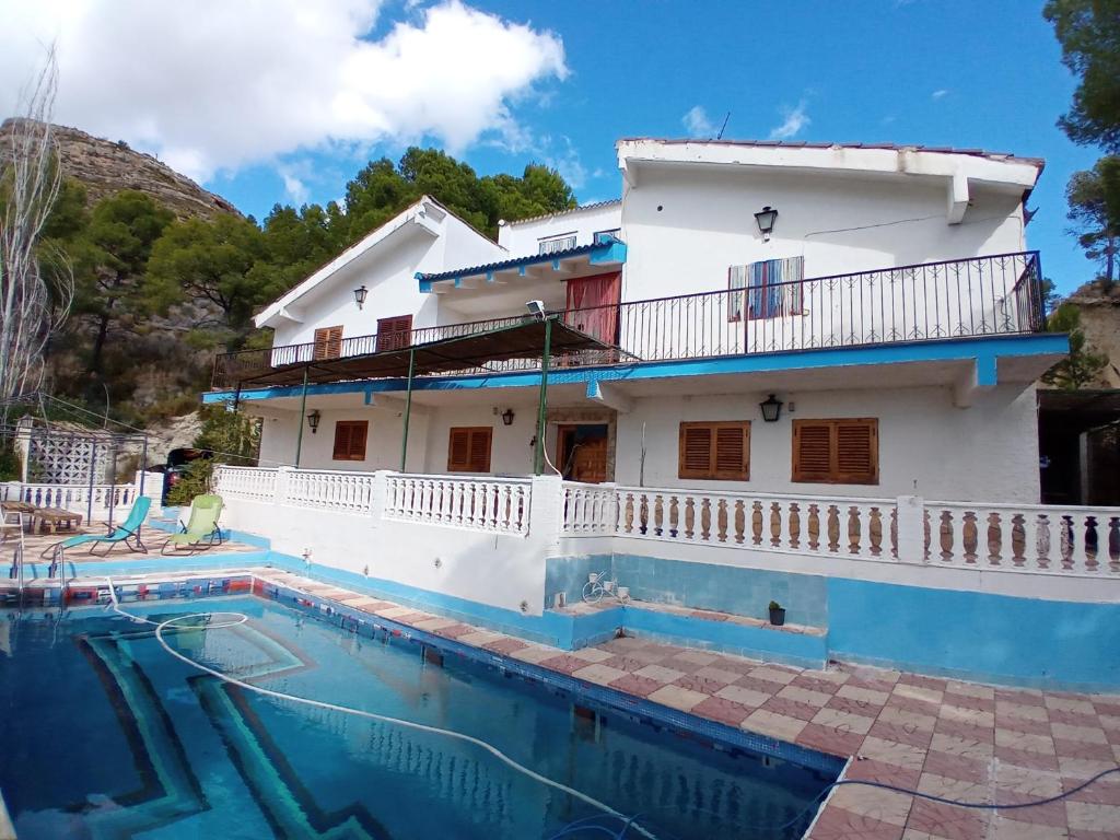 a villa with a swimming pool in front of a house at Picturesque Villa in Chulilla with Private Pool in Chulilla
