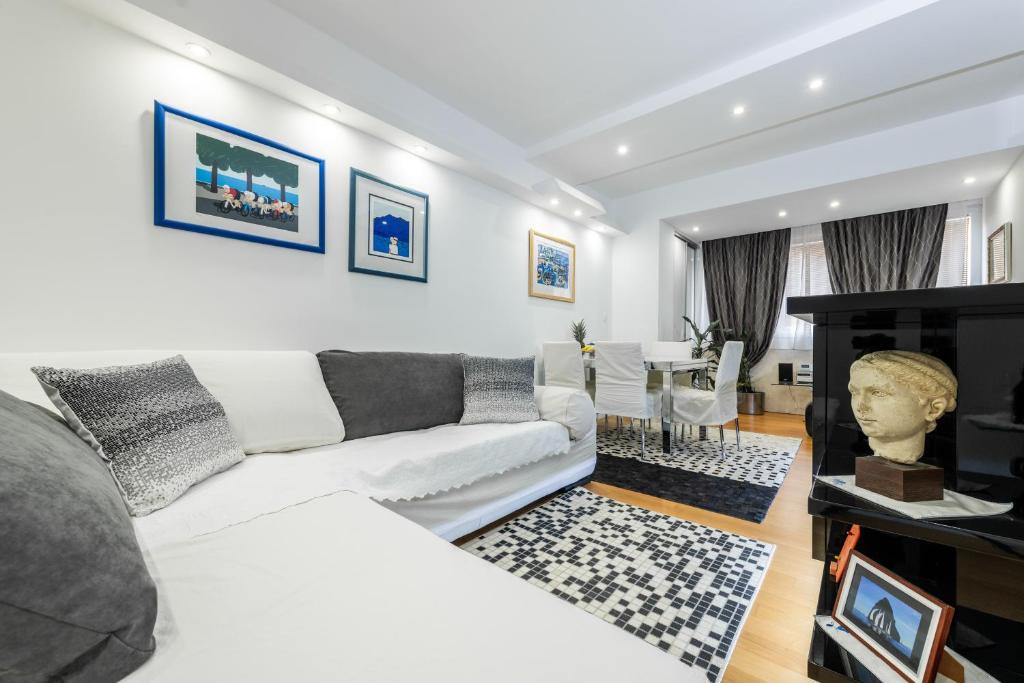 a living room with a white couch and a fireplace at Luxury Apartment Set in Split