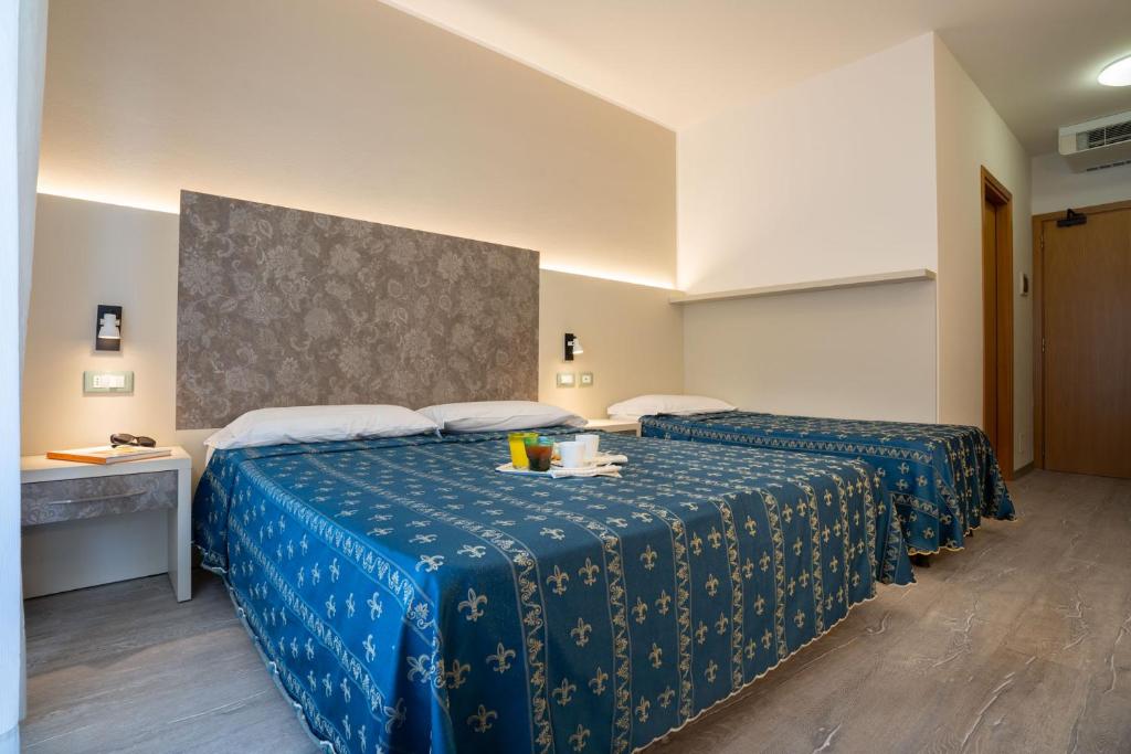 Postel nebo postele na pokoji v ubytování Hotel Ca' D'Oro