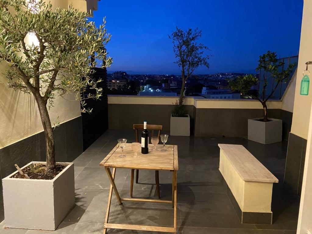 a table and a bench on top of a building at 5-Rooms Apartment in Rome