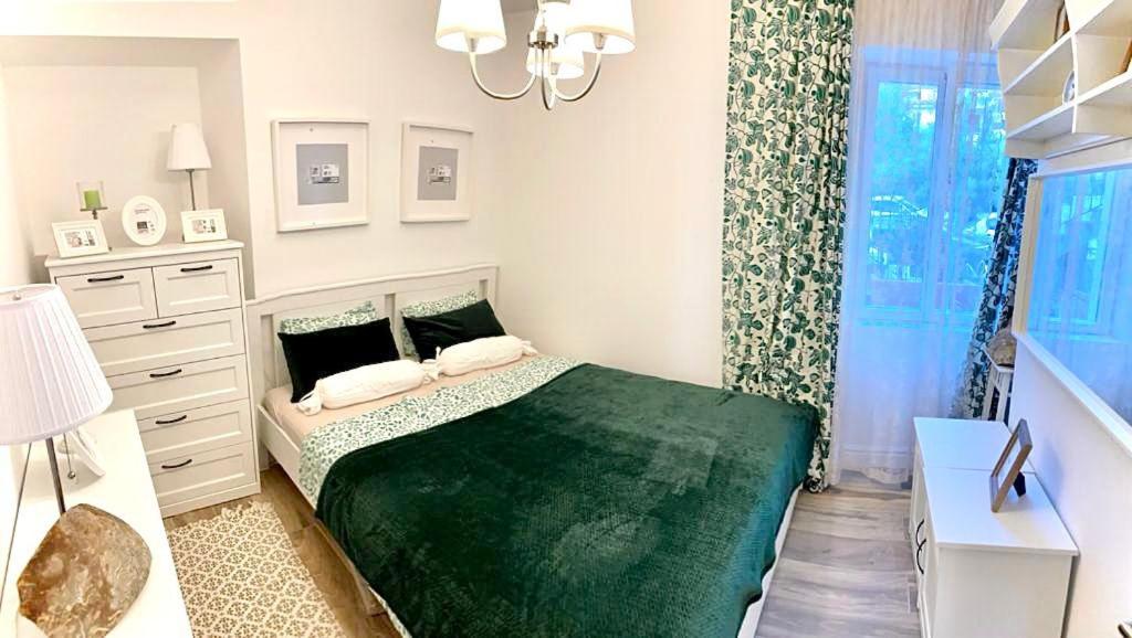 a bedroom with a green bed and a dresser at Apartment Pupa in Brela