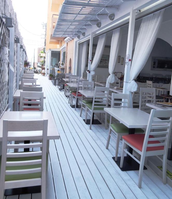 a row of tables and chairs on a patio at Thalia deco City & Beach Hotel in Hersonissos