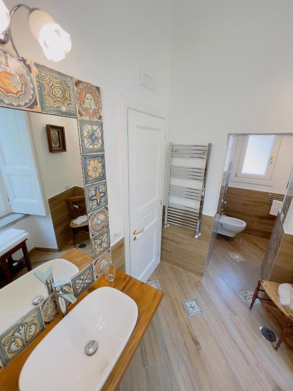 a bathroom with a sink and a mirror at Coco's Apartment in Meta