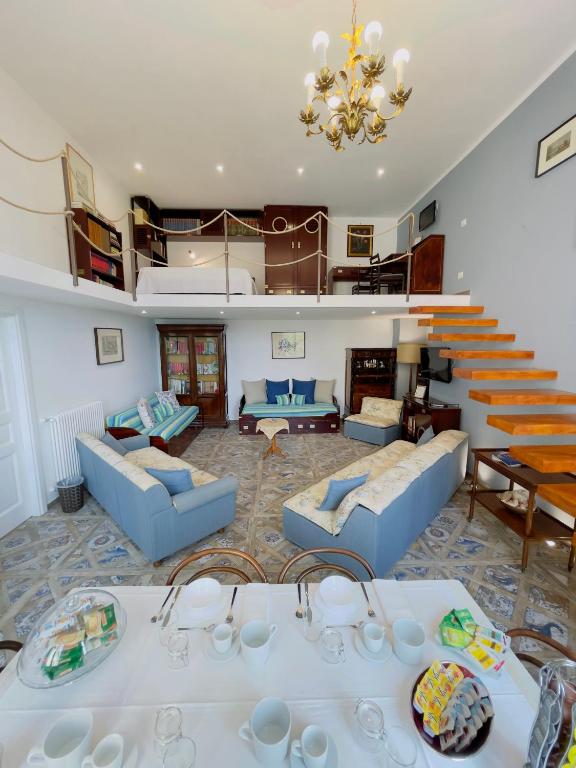 a living room with blue couches and a staircase at Coco's Apartment in Meta