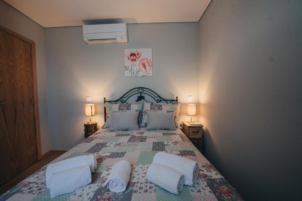 a bedroom with a large bed with two pillows at Ti`Justina Country House in Rossas