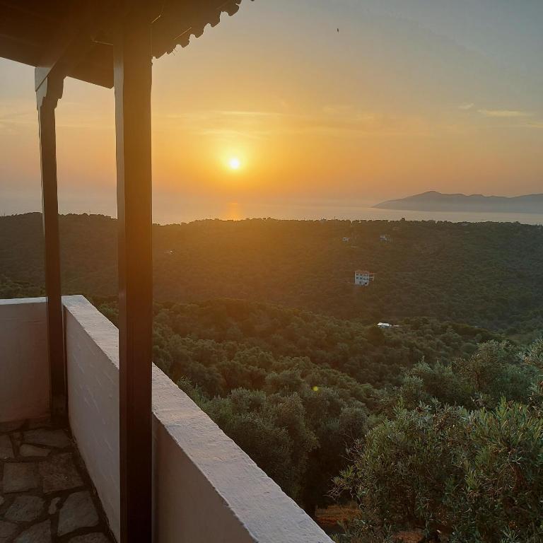 a view of the sunset from the balcony of a house at Villa Amfithea in Skiathos