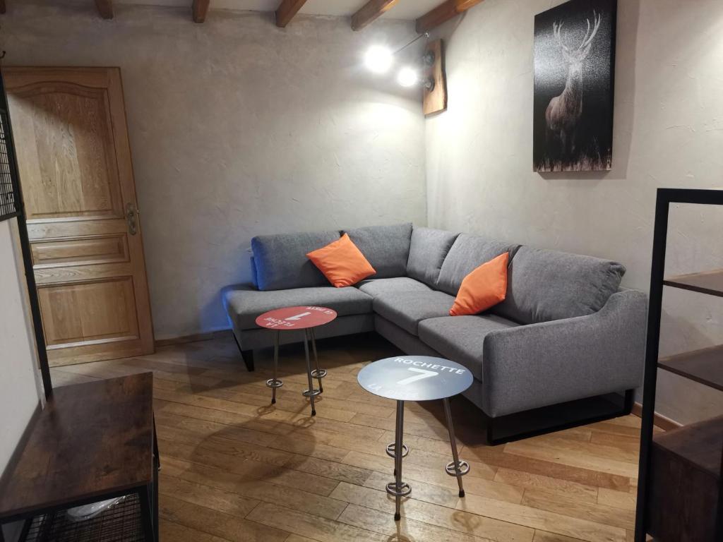 a living room with a couch and two tables at Residence le Cairn in Le Monêtier-les-Bains