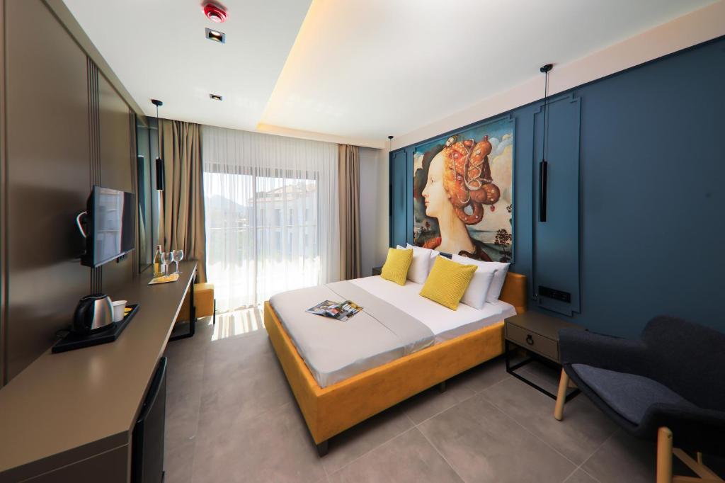 a hotel room with a bed and a television at Neva Kaş in Kaş