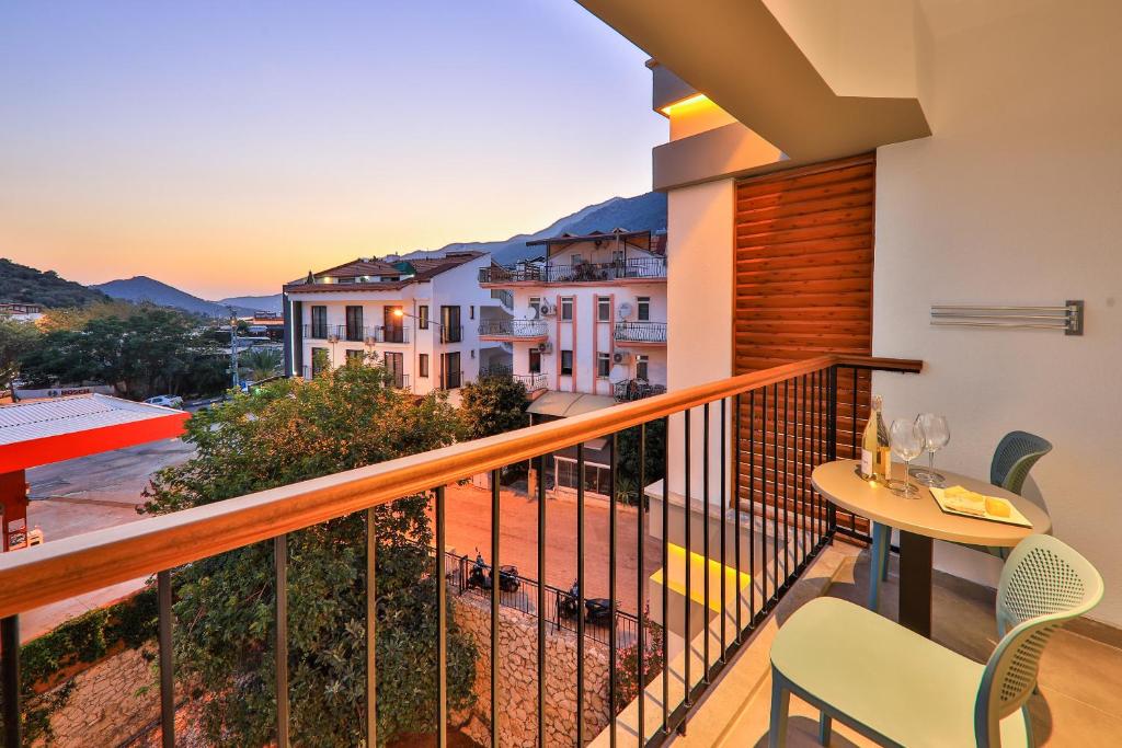 a balcony with a table and chairs and a view at Neva Kaş in Kaş