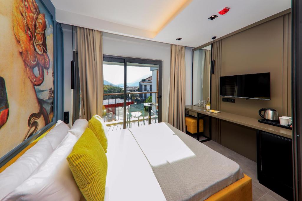 a hotel room with a bed and a desk at Neva Kaş in Kaş