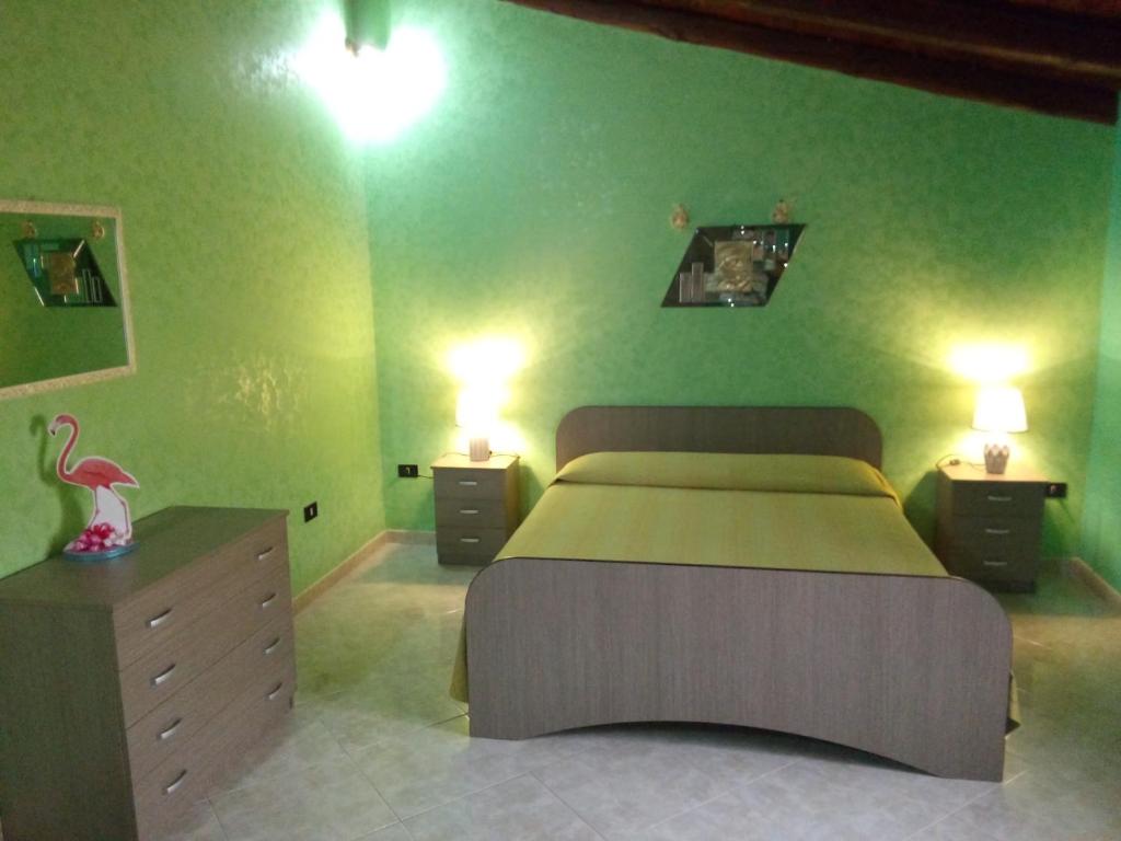 a bedroom with a large bed and two night stands at Casa vacanze a due passi dal mare in Avola