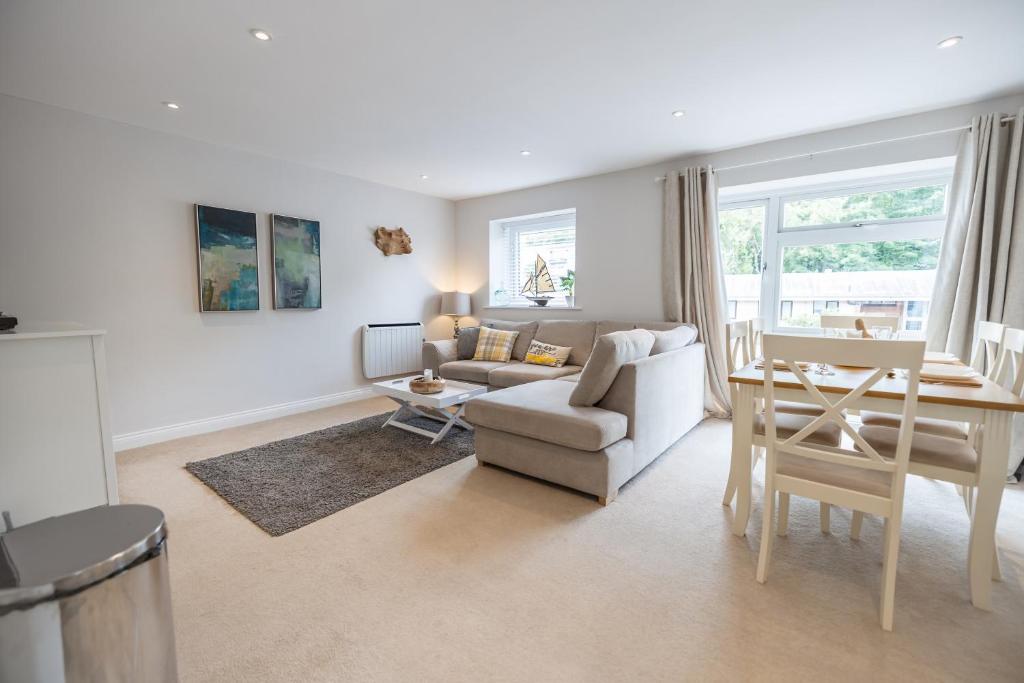 a living room with a couch and a table at Stylish Brixham Apartment - Free on street parking in Brixham