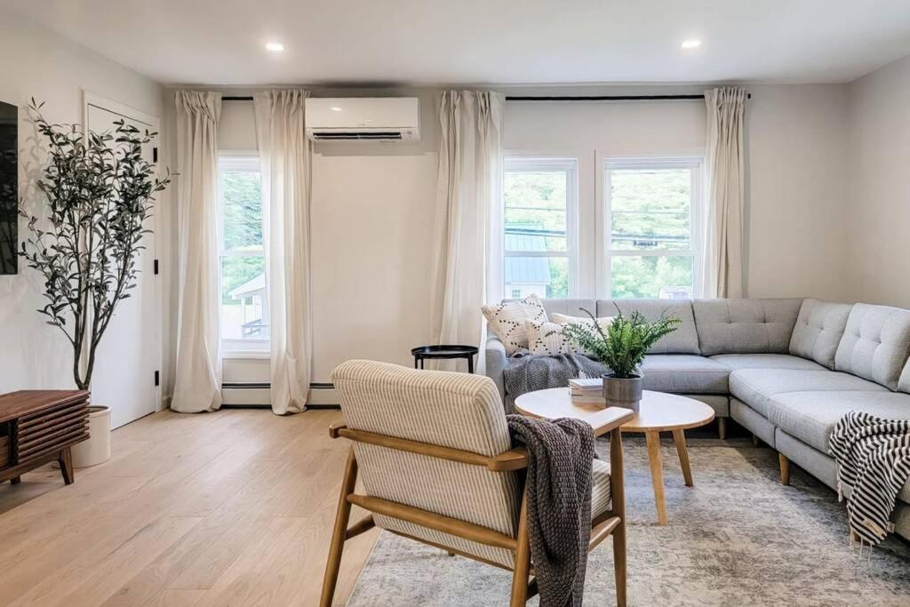 a living room with a couch and a table at River Street Unit 3 - Lake George, Glens Falls in Warrensburg