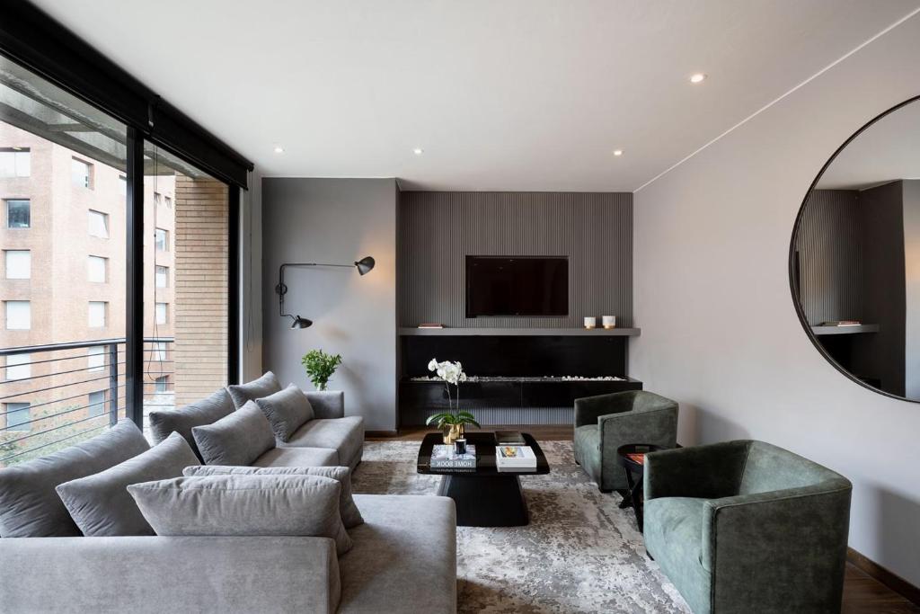 a living room with a couch and a table at Attik Luxury Apts in Bogotá