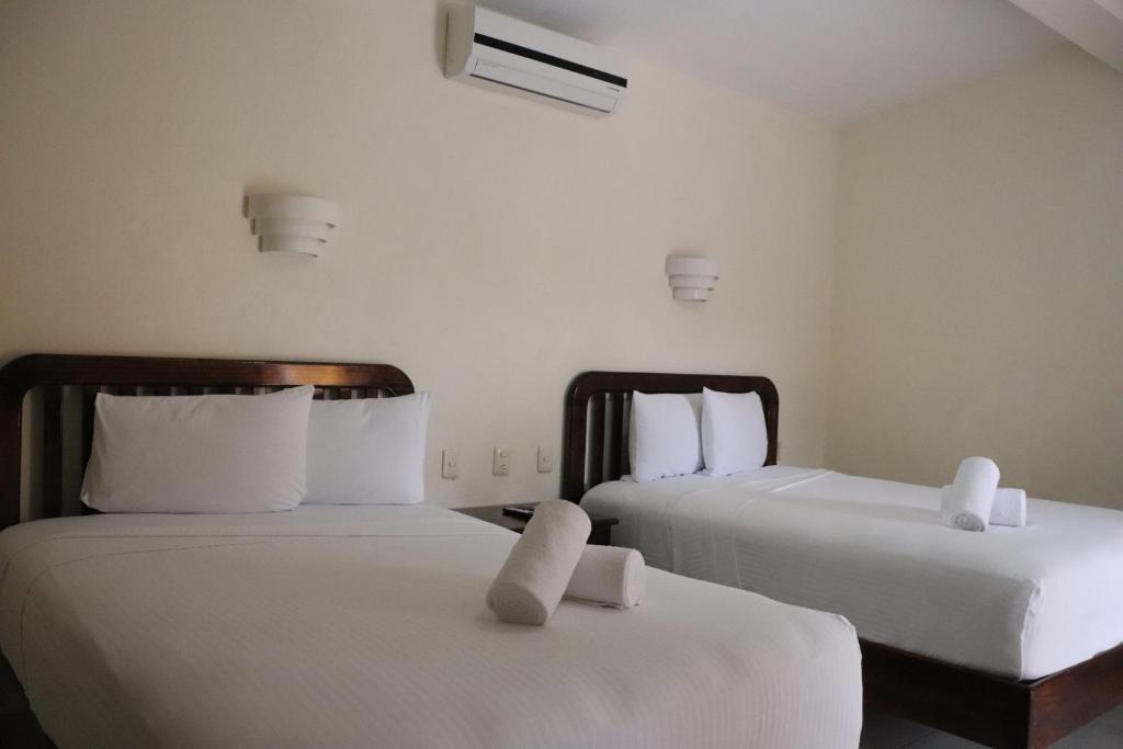 Postel nebo postele na pokoji v ubytování Hotel Caribe