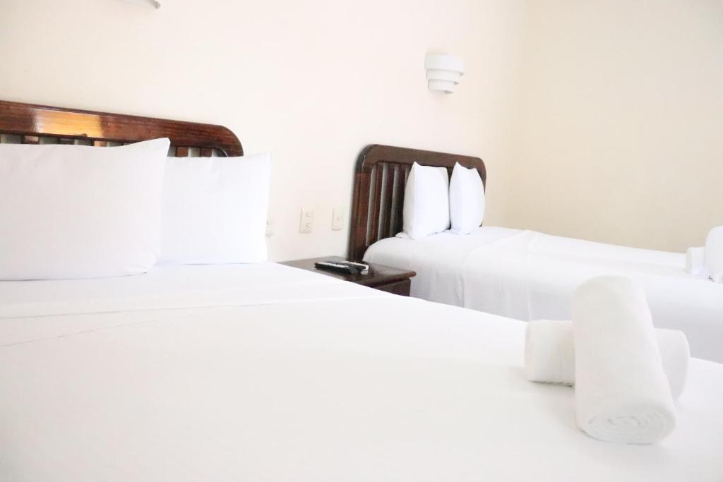 Postel nebo postele na pokoji v ubytování Hotel Caribe