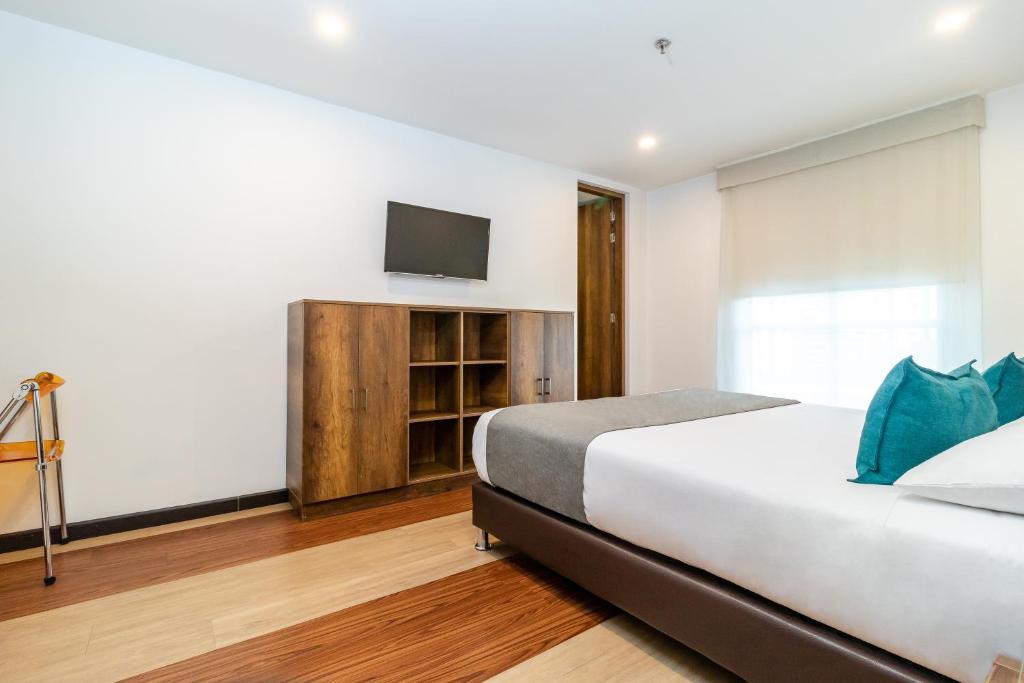 Postel nebo postele na pokoji v ubytování Hotel Black Usaquen