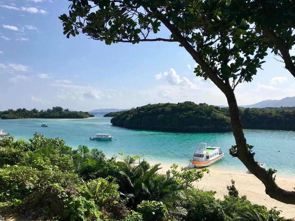a beach with two boats in a body of water at Joya in Ishigaki Island