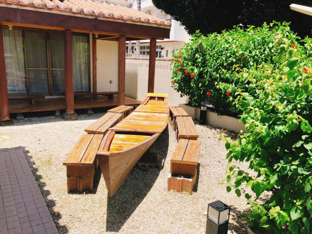 a wooden bench in front of a house at Joya in Ishigaki Island