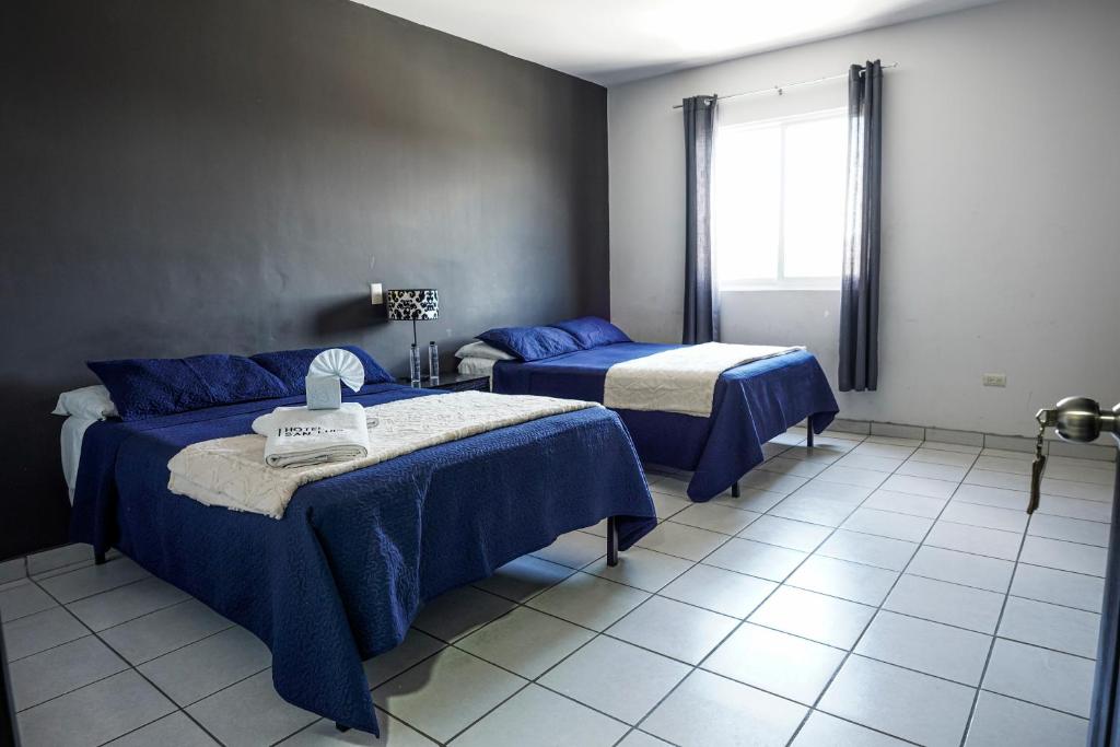Postel nebo postele na pokoji v ubytování Hotel San Luis