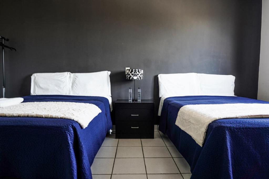 Postel nebo postele na pokoji v ubytování Hotel San Luis