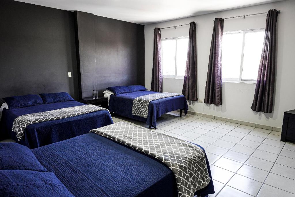 Postel nebo postele na pokoji v ubytování Hotel San Luis
