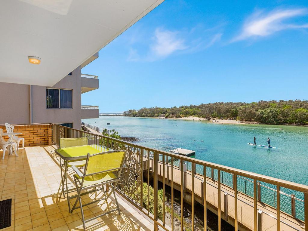 a balcony of a house with a view of the water at Creekfront Kingscliff Waters 2 in Kingscliff