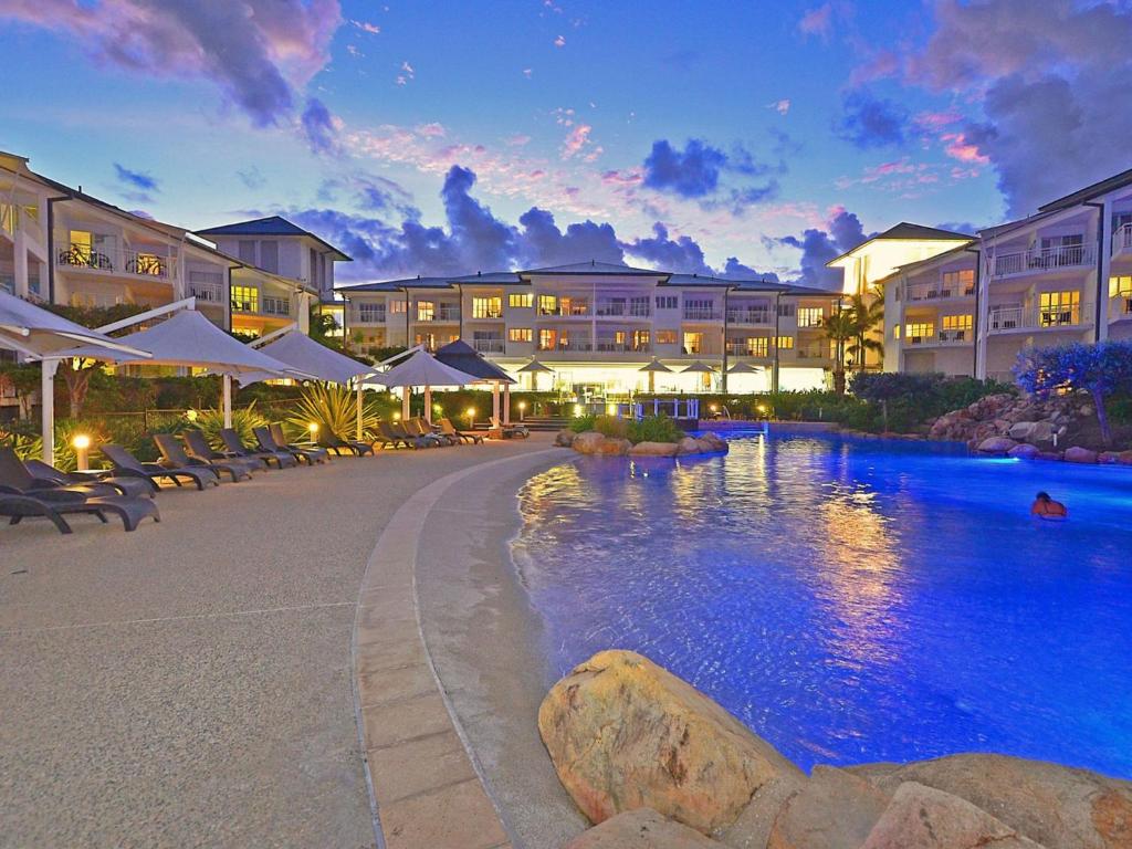 a resort with a swimming pool at night at RESORT ON THE BEACH 2214/2215 in Kingscliff