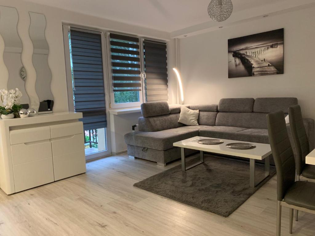 un soggiorno con un divano e un tavolo di Apartament Zabia a Białystok