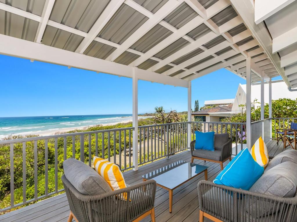 a porch with chairs and a view of the beach at Sandpiper Beachfront House - Hastings Point in Hastings Point
