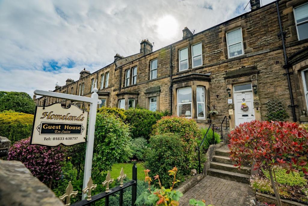 a guest house with a sign in front of it at Homelands Guest House in Barnard Castle