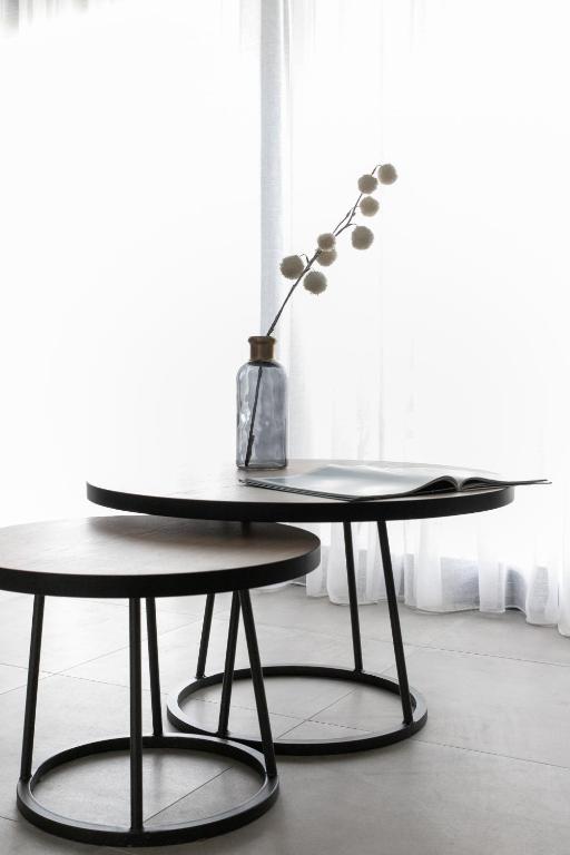 a table with a vase sitting on top of it at The Euphoria Club Luxury Villas in Pefkochori