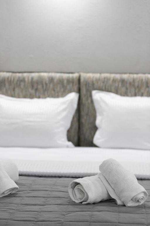 a pile of towels laying on a bed at The Euphoria Club Luxury Villas in Pefkochori