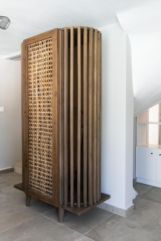 a wooden divider in a room next to a wall at The Euphoria Club Luxury Villas in Pefkochori