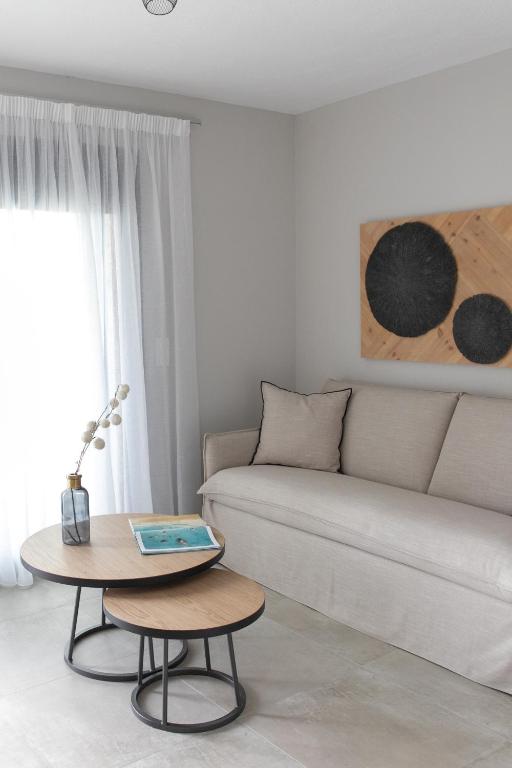 a living room with a couch and a table at The Euphoria Club Luxury Villas in Pefkochori