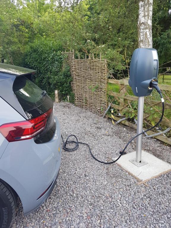 a car is plugged into a electric car charger at Homestead Stables in Market Lavington