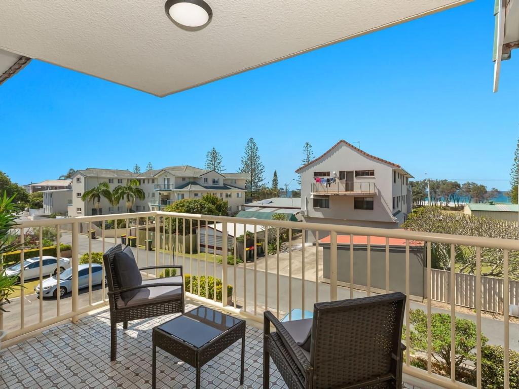 a balcony with chairs and a view of a parking lot at Kingy Beach Getaway with Balcony - Central Kingscliff in Kingscliff