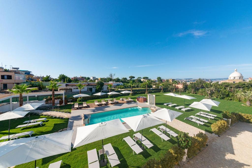 an aerial view of a resort with a pool and lounge chairs at Insula Boutique Hotel in Procida