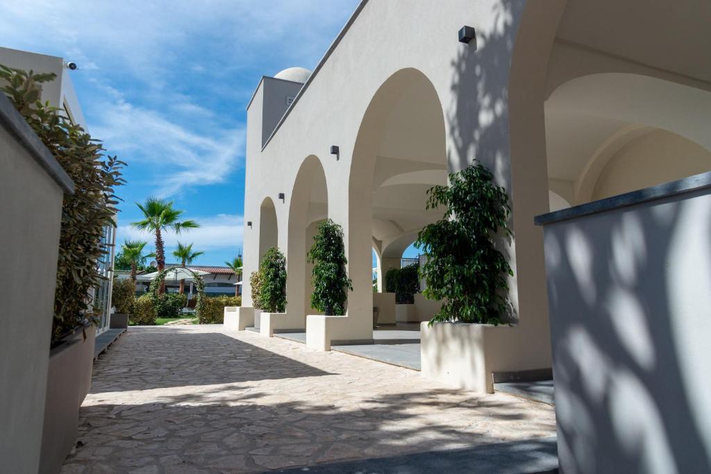 a courtyard of a building with trees on the side at Insula Boutique Hotel in Procida