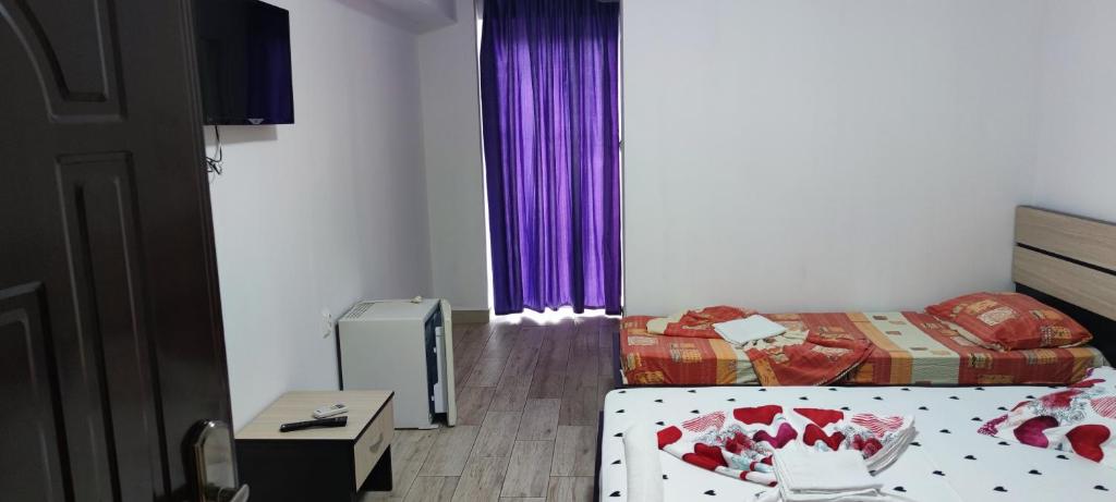Postel nebo postele na pokoji v ubytování Vila Axel