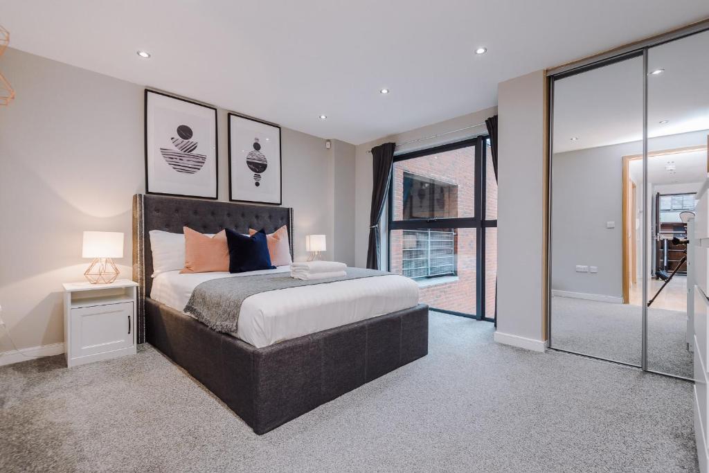 a bedroom with a large bed and a large window at Host & Stay - Duke Street Living in Liverpool