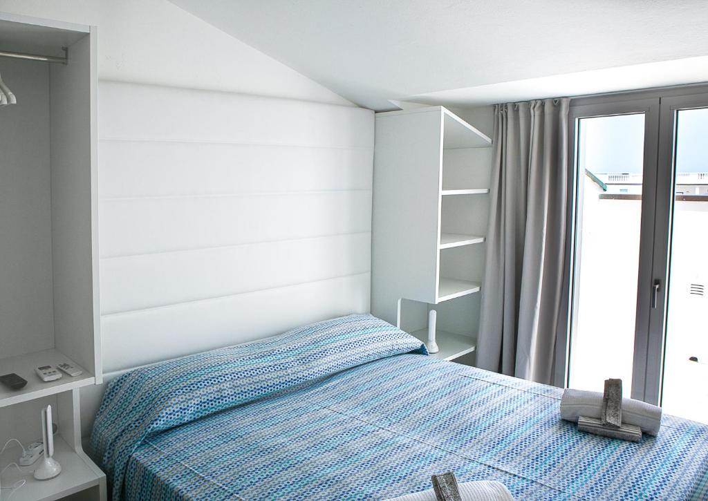 Postel nebo postele na pokoji v ubytování Hotel Ninfea Cattolica