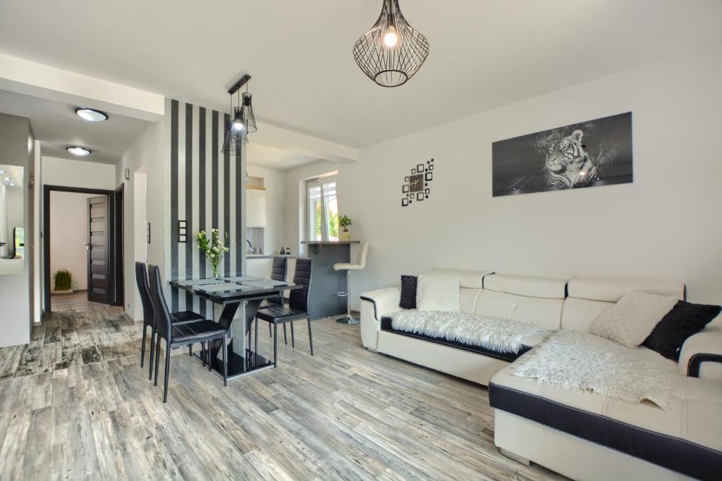 a living room with a couch and a table at Apartament Glamour in Ustrzyki Dolne