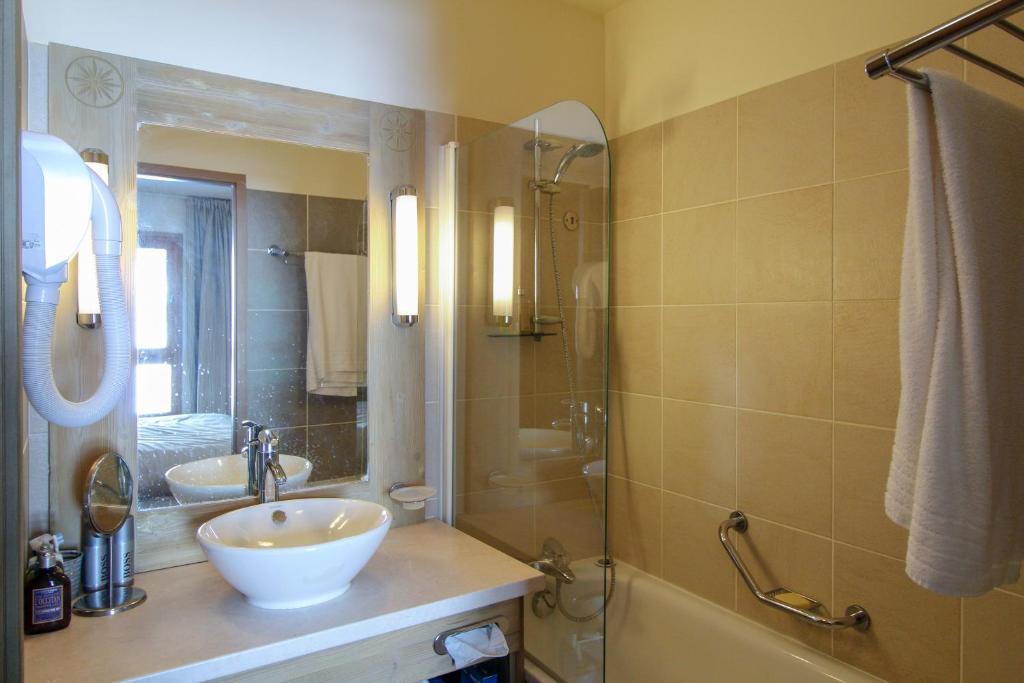 a bathroom with a sink and a shower and a tub at Spacious Family 2-bed, 2-bath with parking, private piste in Flaine