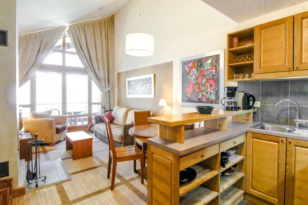 a kitchen and living room with a sink and a table at Les Terrasses d'Eos, 1-bed apartment with fireplace, Ski in, Ski out in Flaine