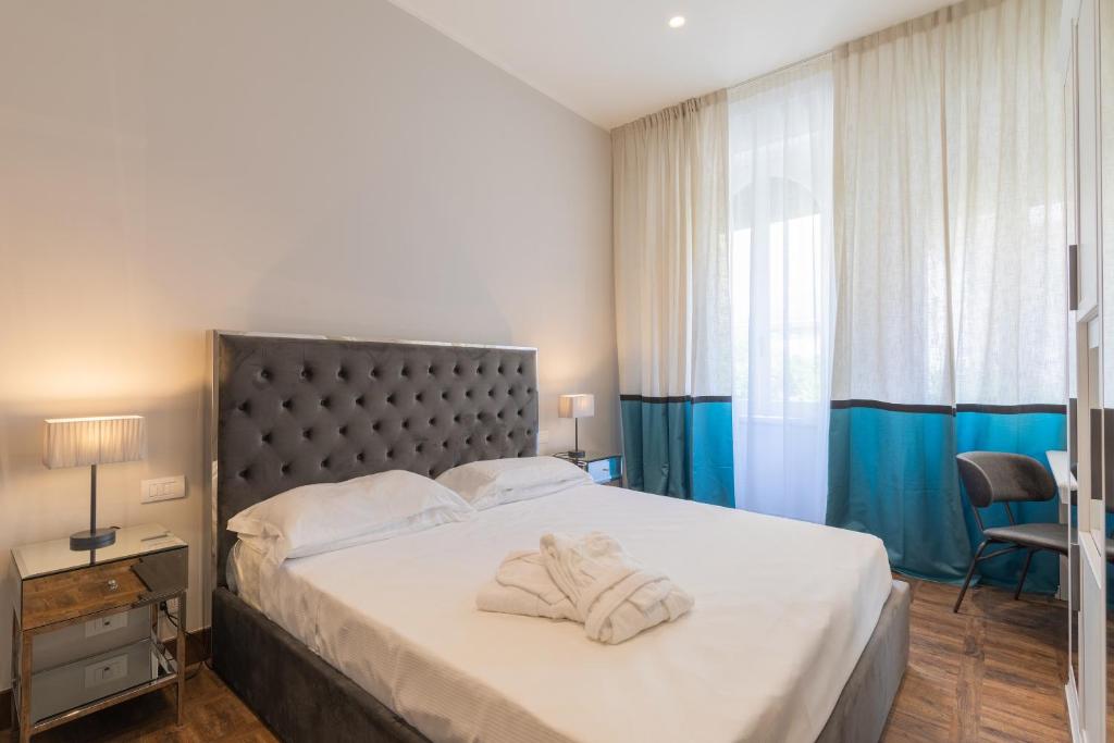 a bedroom with a large bed with towels on it at Hotel Villa Alberti Portofino Land in Santa Margherita Ligure