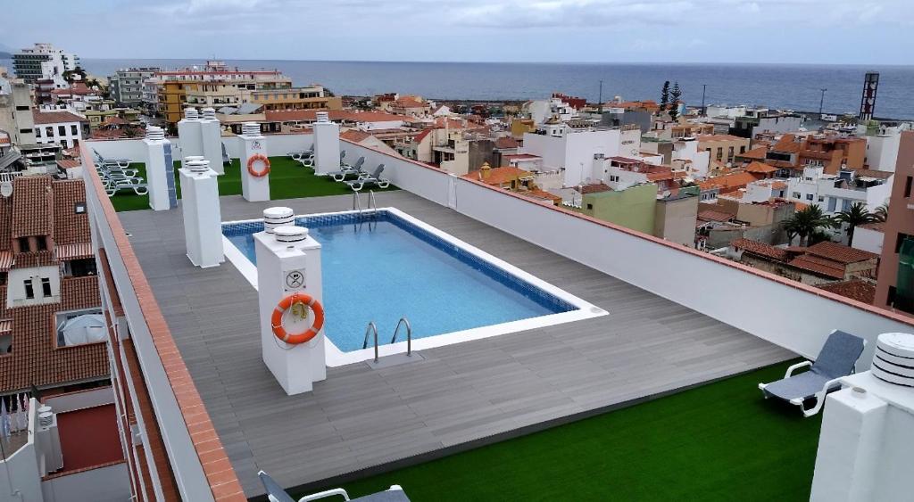 - un balcon avec une piscine au-dessus d'un bâtiment dans l'établissement Unica Via Apartment Edificio Girasol, à Puerto de la Cruz