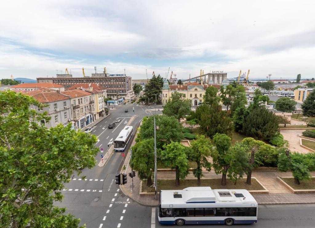 a bus driving down a street in a city at Seaman's house in Burgas City